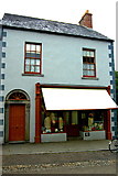 R4561 : Bunratty Park - Village Street Site #12E - Sean O'Farrell's Drapery by Joseph Mischyshyn