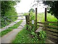 Footpath stile by gated track