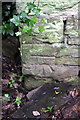 Benchmark on stone hut beside Parkside