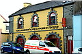 R0579 : Miltown Malbay - Main Street (N67) - Tom Malone's Pub & Market House by Joseph Mischyshyn