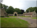 TF8943 : Almshouses and entrance arch, Holkham Park by Richard Humphrey