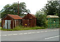 Two rusty corrugated buildings and a bus shelter, Sennybridge