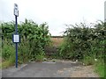 Bus stop at a blocked field entrance