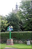 TF8709 : All Saints' church tower looking over the 'Neketona'/Necton village sign by Peter Turner