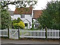 Weather-boarded cottage by Godstone village pond