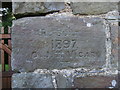 Engraved stone in Church gatehouse wall of St. Tyssilio