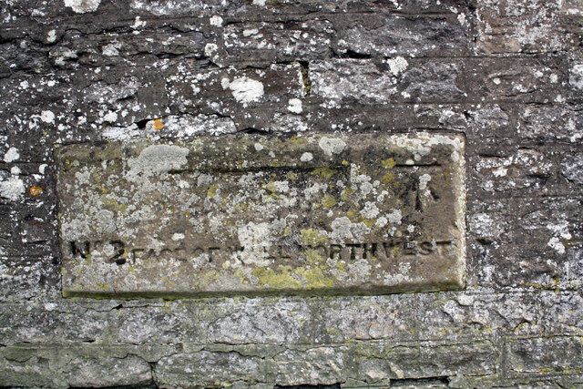 Benchmarked inscribed stone in wall of Cutpurse Lane