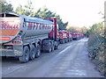 TL2809 : Lorries belonging to gravel workings by Bikeboy