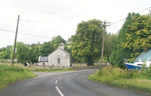 A bend in the Lough Shore Road by Slawin's CoI Parish Church