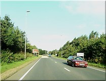 NX9877 : Approaching a roundabout at the junction of the A75 and the A701 by Ann Cook
