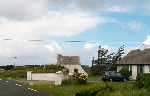The remnant of a traditional cottage and its modern replacement on the shores of Lough Meela