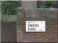 Street nameplate mounted on a brown brick wall