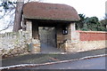 Thatched gate to the church and bus shelter