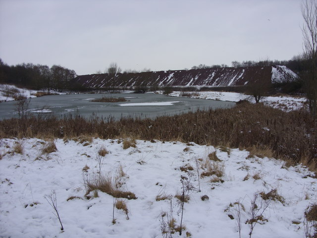 Frozen pond and large stockpile of road salt, Meadowbank Salt Mine