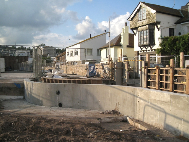 Curved flood wall under construction by Gales Hill