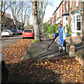 Blowing leaves off the footway, Broad Street CV34