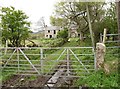 Lane leading to derelict farmhouse on the southeast side of the B180