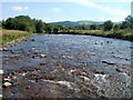 Afon Sawdde flows towards a weir near Llangadog