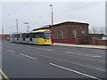 Metrolink Tram passing Droylsden Library