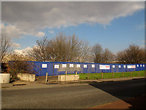 TQ4078 : Blue hoarding on Woolwich Road by Stephen Craven