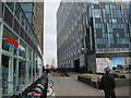 View of the path leading to the Thames between Tesco Express and new retail units from the path