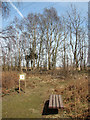 Seat and information board beside a path at Toby