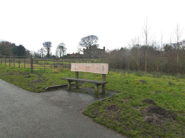 A bench with Cuerden Hall in the distance
