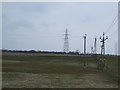 NU2107 : Farmland and pylons, Sturton Grange by JThomas