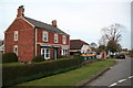 Fine brickwork and wrought iron fence in front of a cottage at Marshchapel