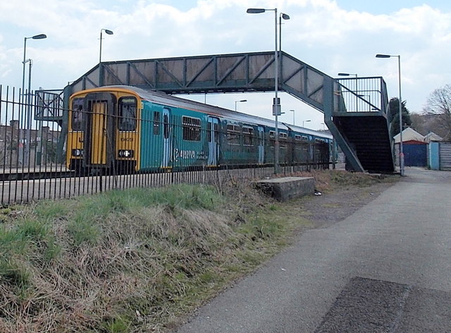 Train under the footbridge at Pengam station