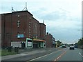 SJ4191 : A57 passes an old cinema building in Dovecot by Anthony Parkes