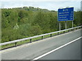 TQ3252 : Anti-clockwise M25 mileage sign near Black Bushes by Colin Pyle
