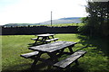 Picnic tables and a view of Darwen Tower