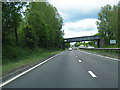 A77 northbound passes under railway bridge