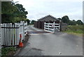 Cattle grid and lodge on the lane to Ashfield, Howey