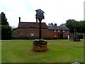 Village sign, war memorial and cottages, Sywell