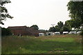 Caravans and old barns behind Walesby Grange