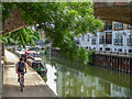 Cycling under the Bridge over the Limehouse Cut, Limehouse, London