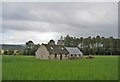 NH6250 : Barns in a field by Richard Dorrell