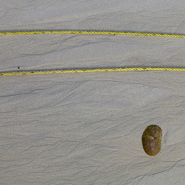 Yellow rope, pebble and dendritic sand patterns