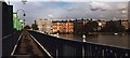 Going north over footbridge alongside District Line rail bridge in Putney