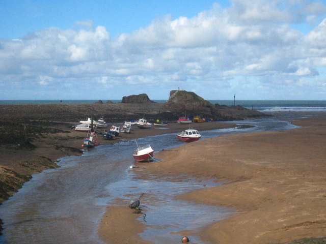 The River Neet flowing across the beach to the sea
