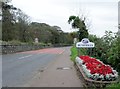 Flower bed and Town Name Sign at the entrance to Bushmills