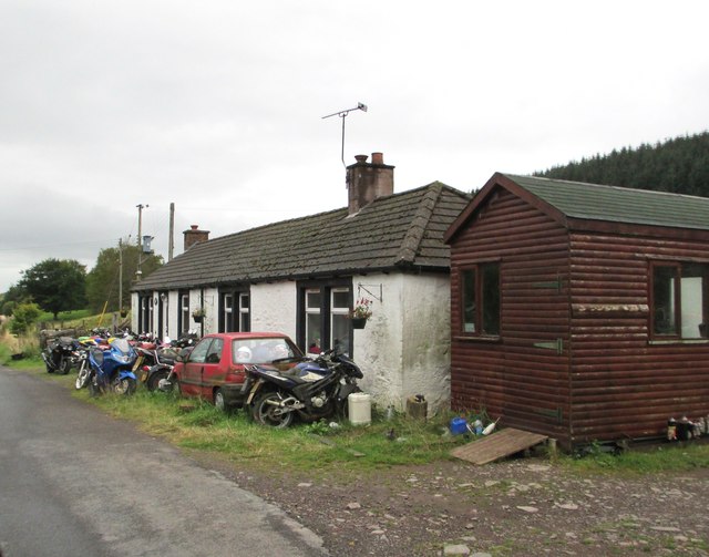 A cottage with motorbikes at Burnfoot
