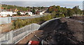 Railway spur in a cutting between two grey fences, Newport