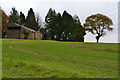 Barn and trees on skyline near Hinton Manor