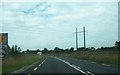N3896 : Powerlines crossing the N55 south of Ballinagh by Eric Jones