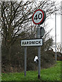 TL3659 : Hardwick Village Name sign by Geographer