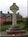 War memorial with houses beyond