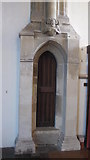 TL8741 : St. Peter's Church, Sudbury - narrow doorway and angel by Mike Quinn